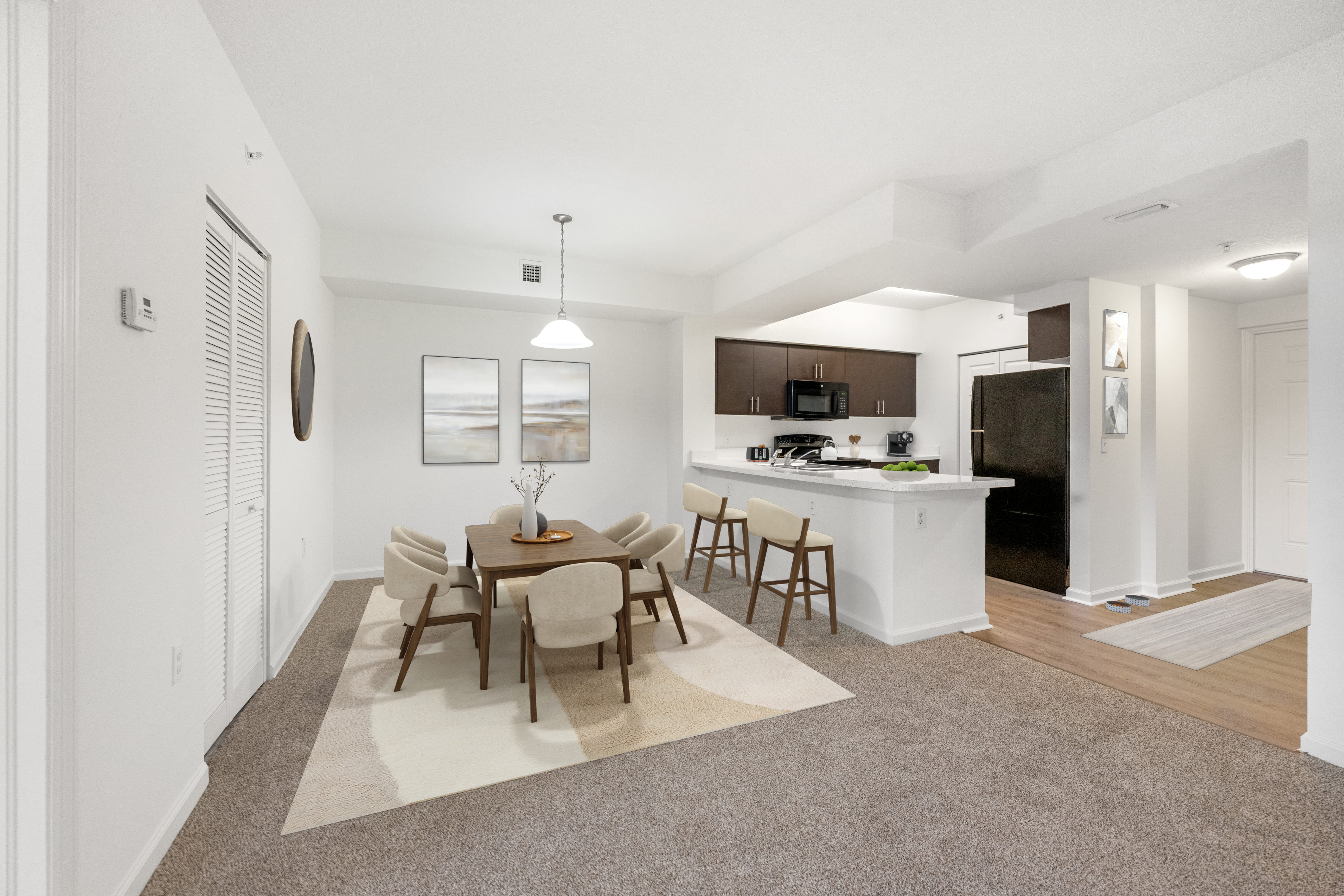 A dining room with a table set for six.